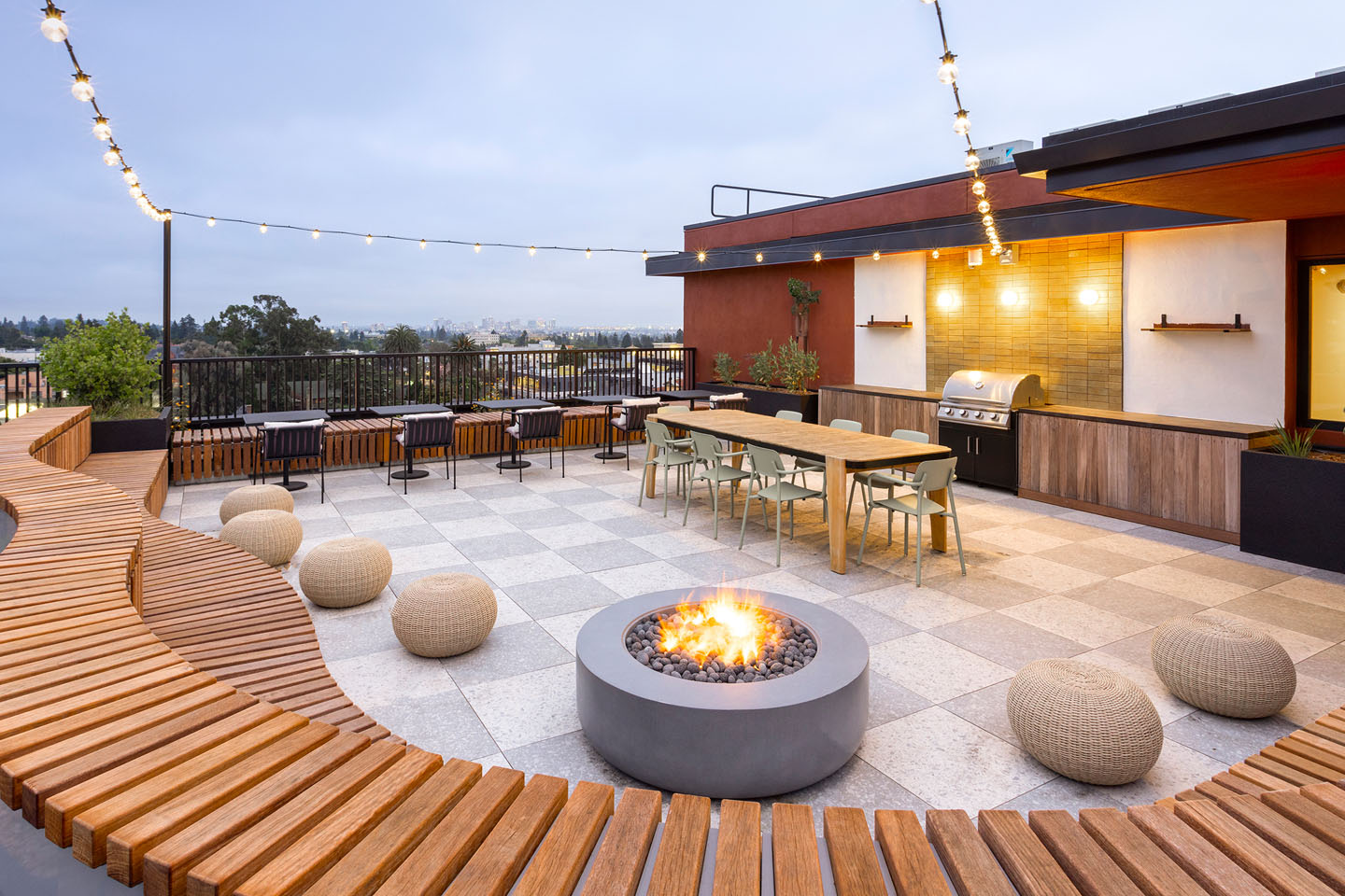 Rooftop lounge with ample seating, grills, and a fire pit.